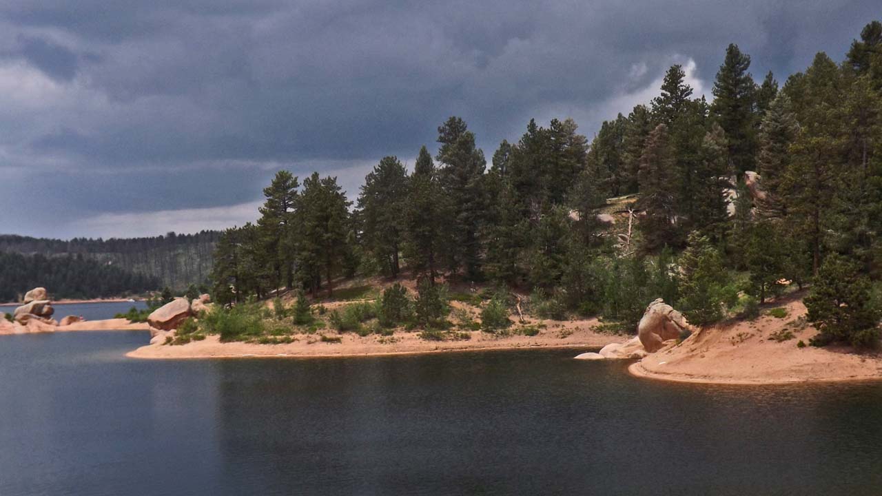 mountain lake with dark clouds approaching